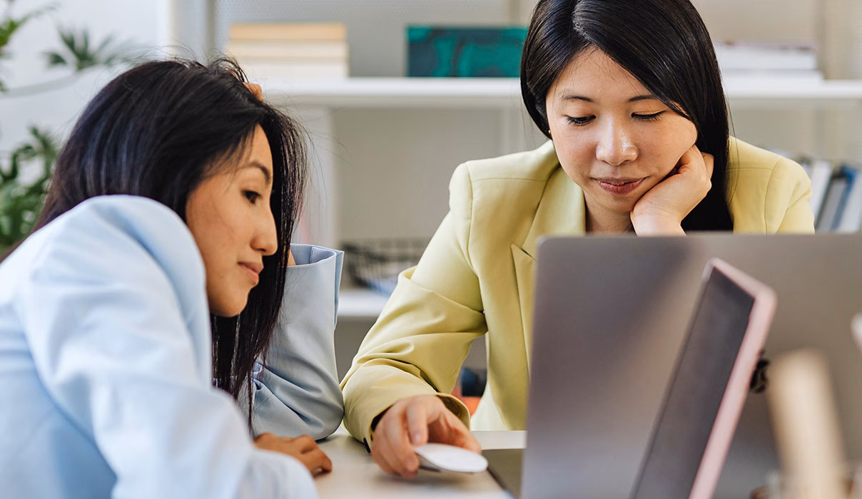 Two Women Looking at Laptop